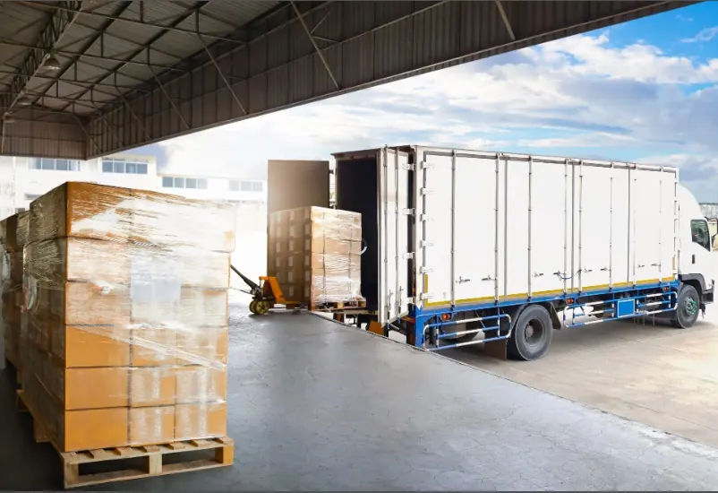 Truck being loaded with cargo at a warehouse dock